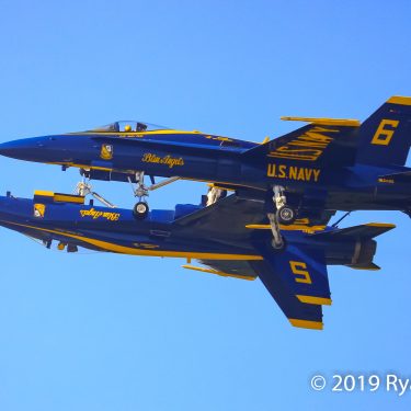 Blue Angels ppposing solos #5 and #6 fly in close formation Copyright Ryan Healy 2019